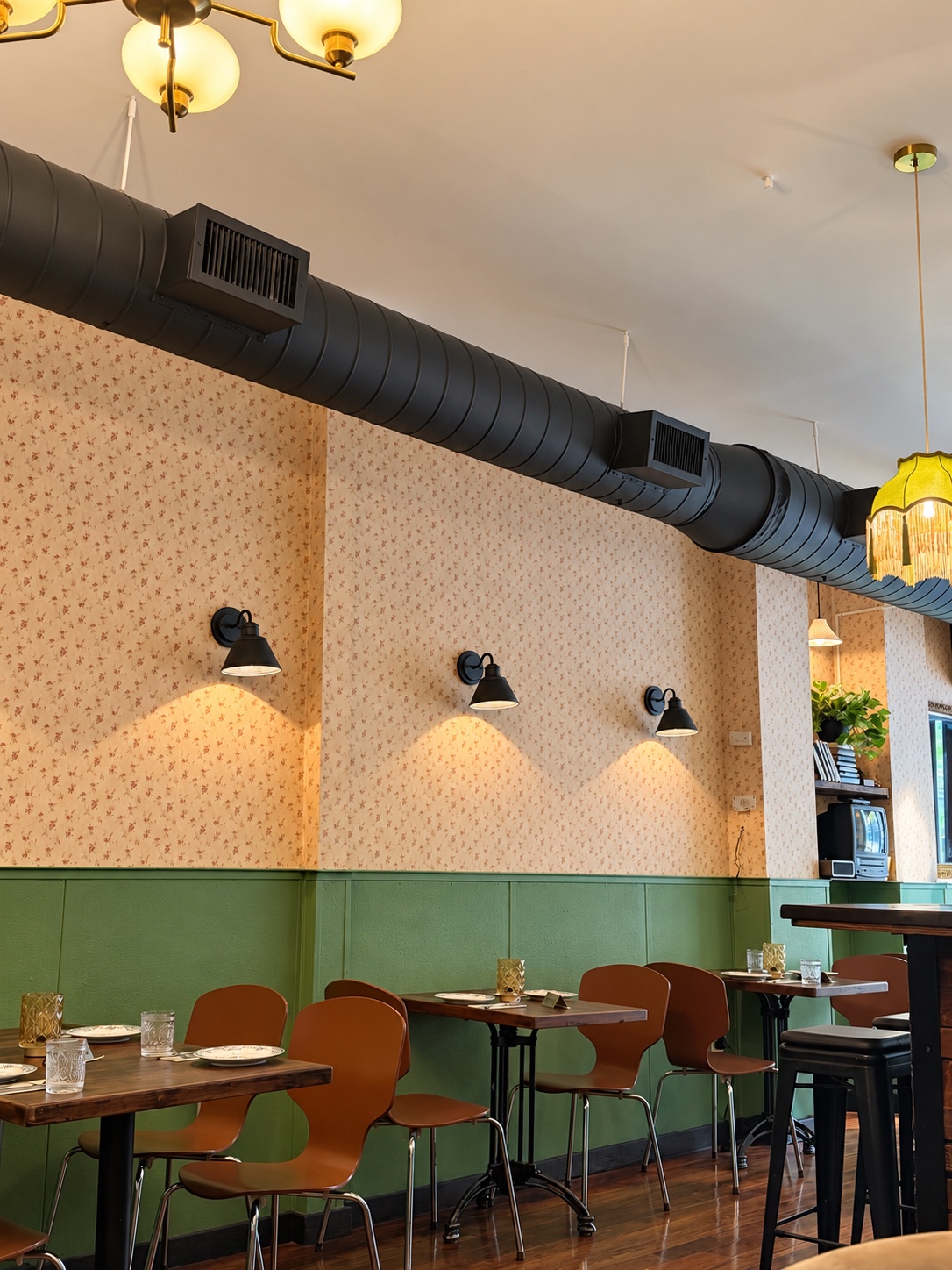 Intimate tables along the green wall